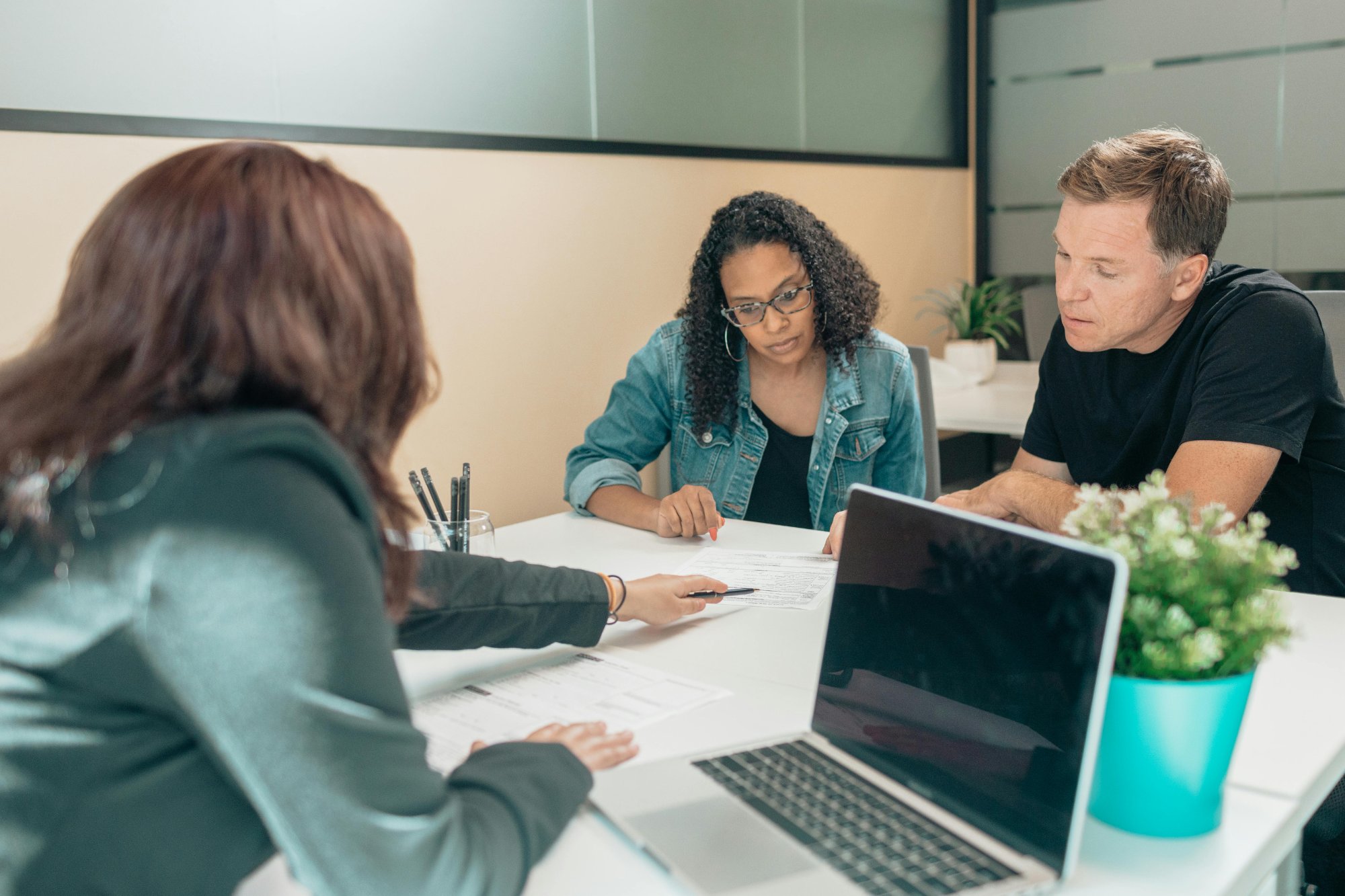 Aafam Link LLC tax professionals reviewing financial documents with clients at a conference table