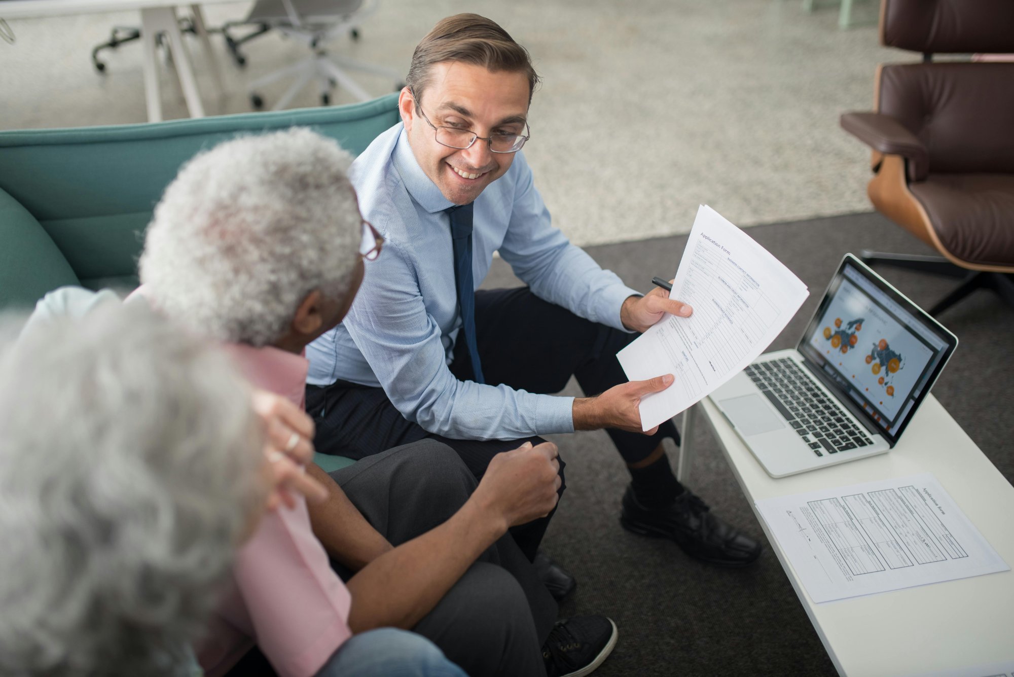 Aafam Link LLC tax preparer smiling while reviewing documents with a client — Newport News, Virginia